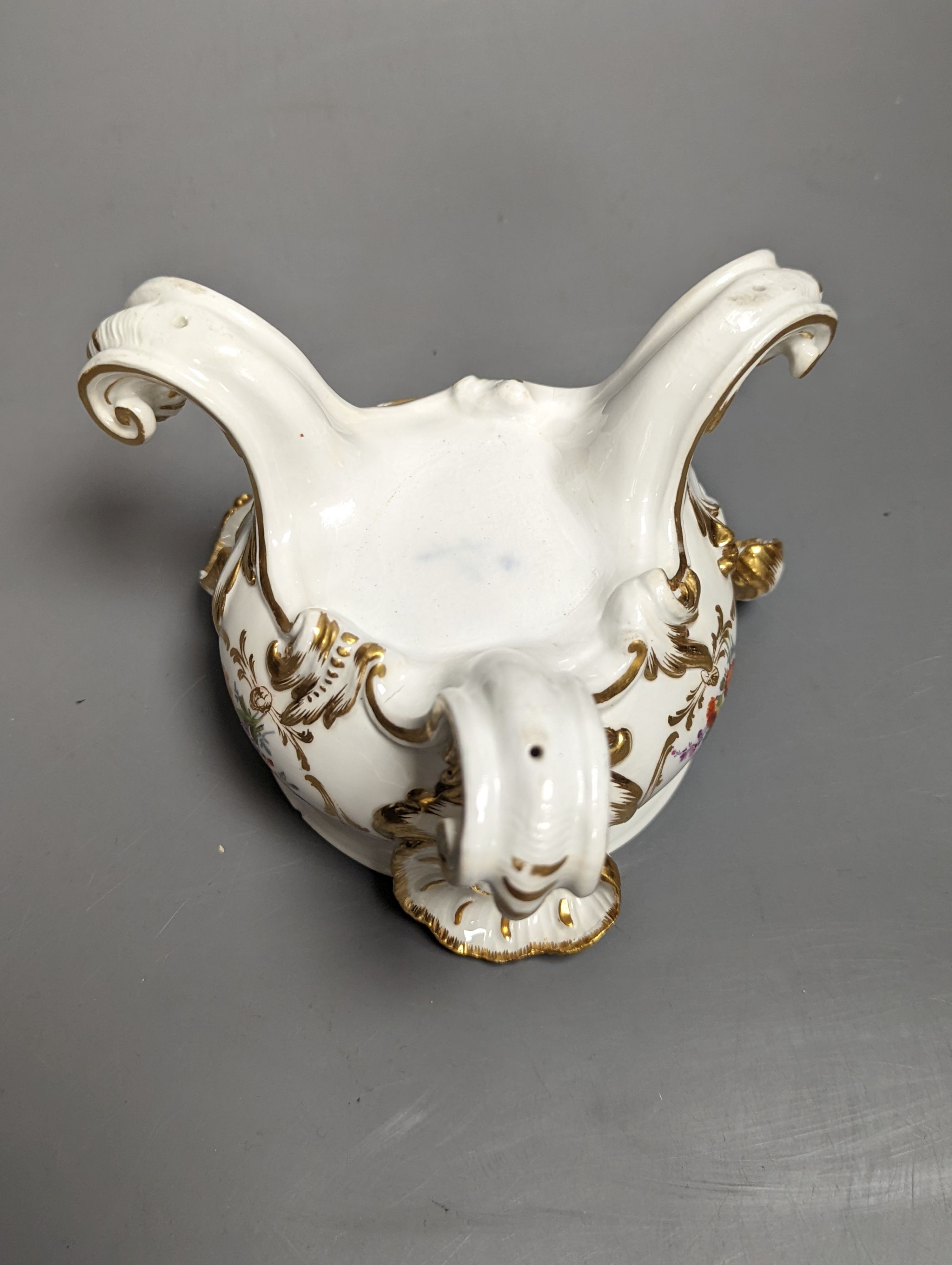 A Meissen pot pourri urn and cover, Marcolini period, on four feet painted with flowers in gilded cartouche under a feather edge border, crossed swords in blue, height 12cm
